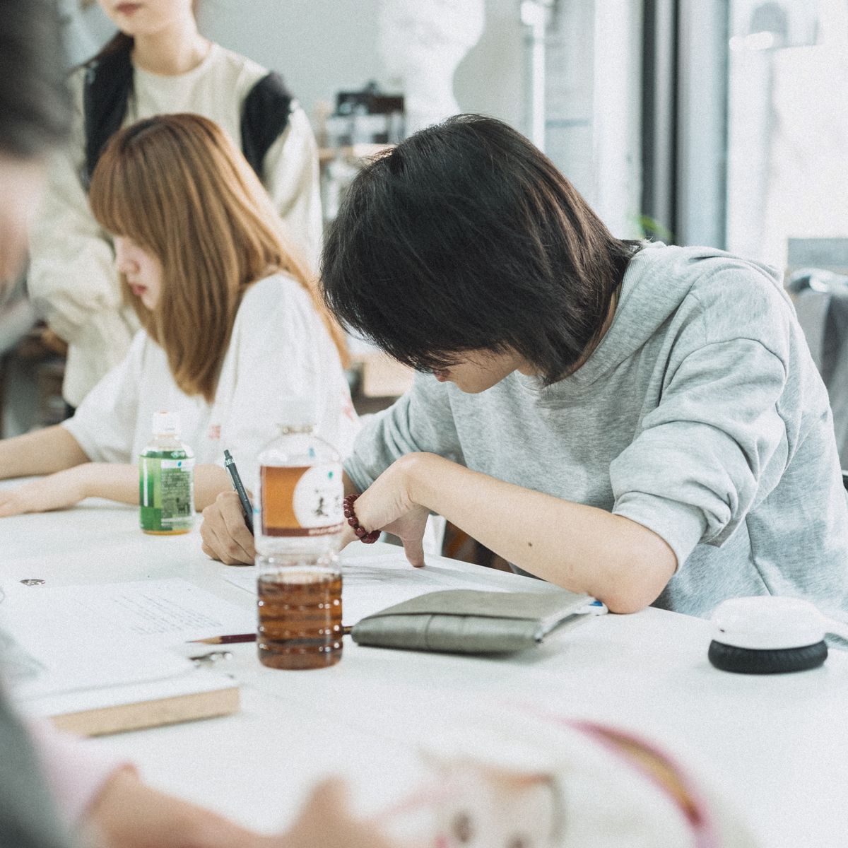 Students in a focused group study session at a Tokyo university