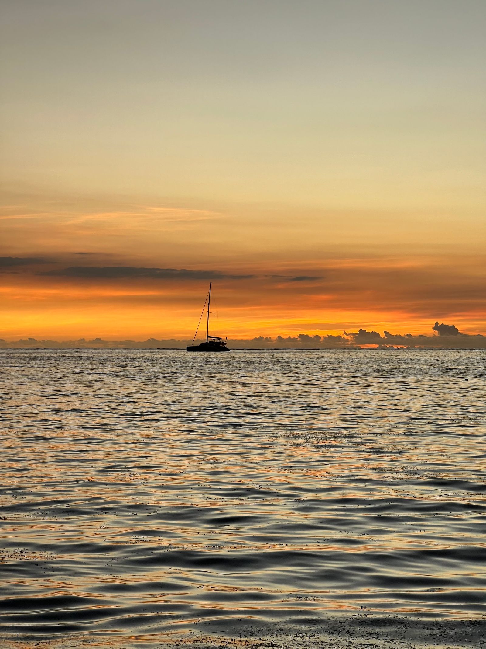 Sailboat at sunset off Grand Baie beach, Mauritius