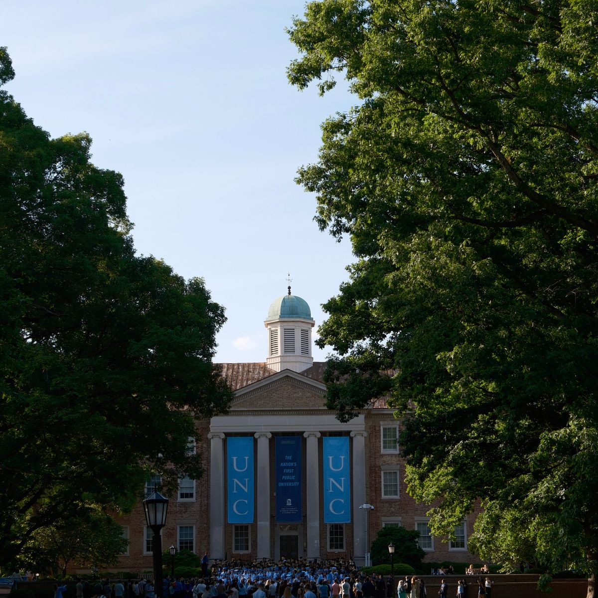 Students crossing a leafy American university campus